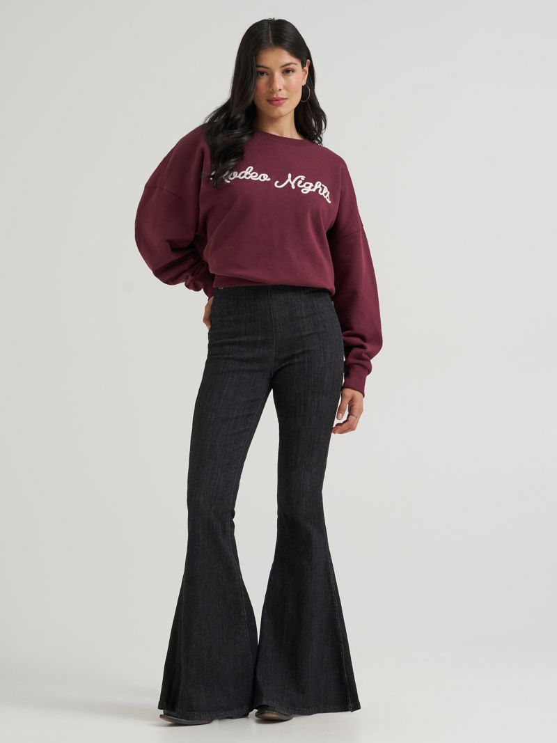 Washed black bell-bottom jeans with a slim knee and a very full lower opening